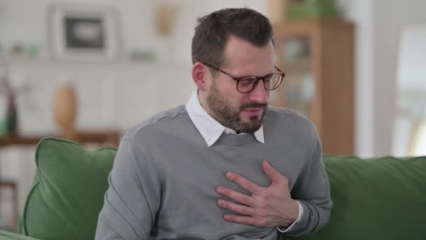 Middle Aged Man having Sudden Pain in Heart on Sofa — Stock Video