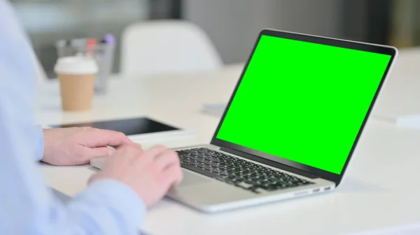 Giovane uomo che utilizza il computer portatile con schermo cromato — Foto Stock