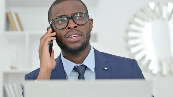 Portrait of African Businessman with Laptop Talking on Phone —  Fotos de Stock