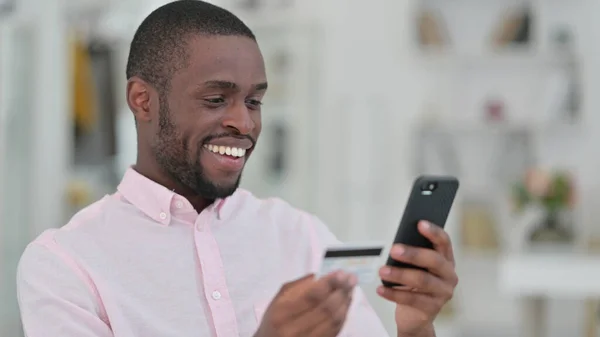 非洲男人在智能手机上做网上支付的肖像 — 图库照片