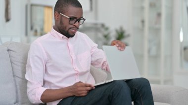 Afrikalı Adam Koltukta Oturuyor ve Bilgisayarı Açıyor 