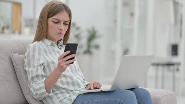 Young Woman using Smartphone and Laptop at Home — Stock Photo, Image