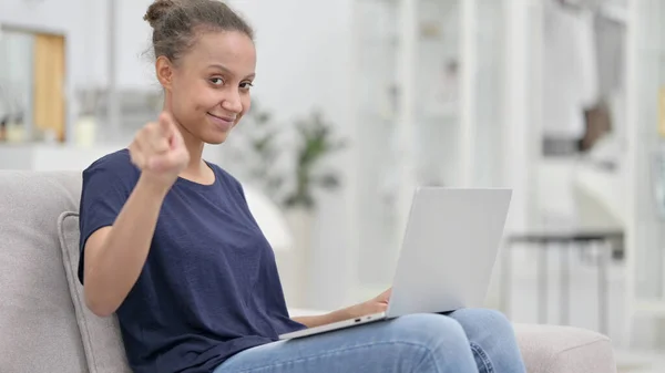 カメラを指差すノートパソコンを持つ興奮した若いアフリカ人女性 — ストック写真