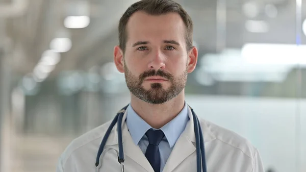 Portret poważnego lekarza patrzącego w kamerę — Zdjęcie stockowe