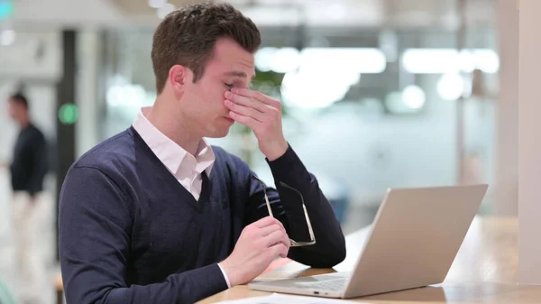 Stresowany młody biznesmen z laptopem z bólem głowy — Zdjęcie stockowe