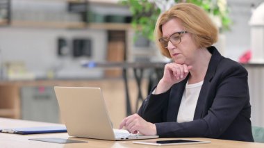 Eski İş Kadını Ofisteki Bilgisayarda Düşünüyor ve Çalışıyor