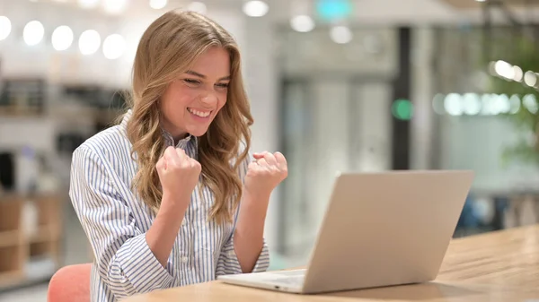 Empresaria emocionada celebrando el éxito en el ordenador portátil en la oficina —  Fotos de Stock
