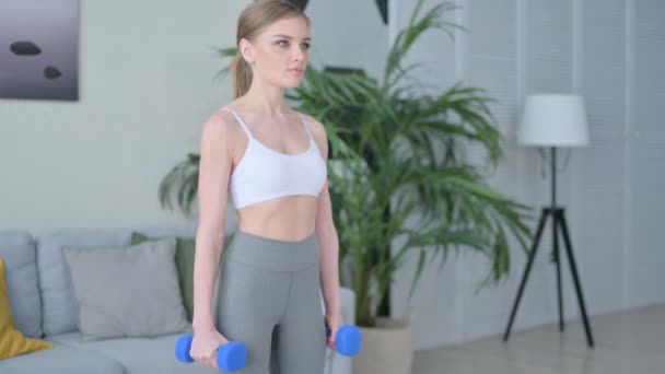Sporty Young Woman Working out with Dumbbells at Home — Stock Video