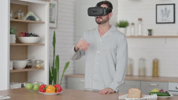 Modern Young Man using VR Set while Standing in Kitchen — Stock Video