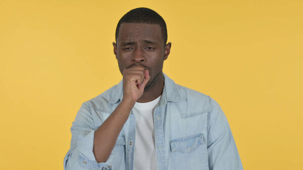 Sick Young African Man Coughing on Yellow Background
