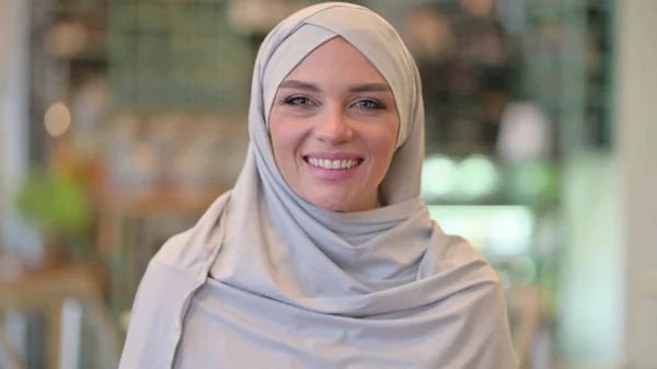 Portrait of Smiling Young Arab Woman Looking at Camera