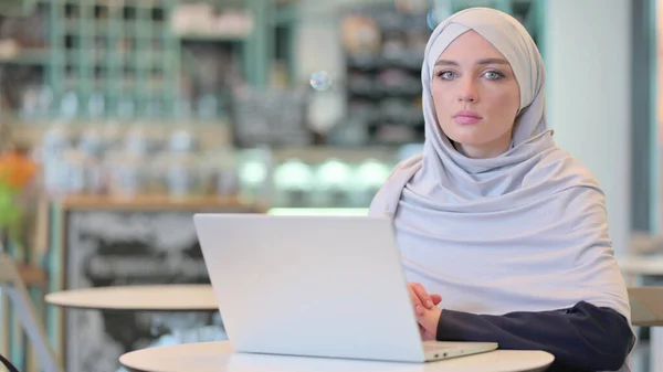 Young Arab Woman with Laptop Looking at the Camera