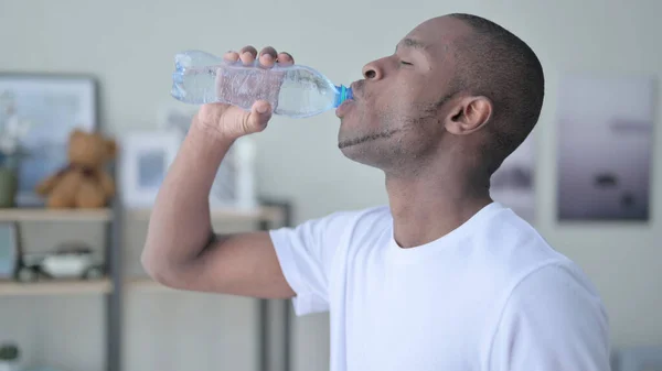 Közelkép az afrikai férfi ivóvíz otthon — Stock Fotó