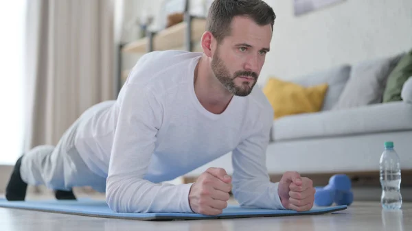 Close up of Strong Mature Adult Man doing Plank on Yoga Mat at Home — Stockfoto