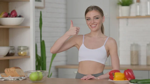 Woman Showing Thumbs up while Standing in Kitchen — Stock Photo, Image