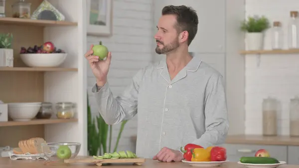 Healthy Man Holding Apple in Kitchen — Stock Photo, Image