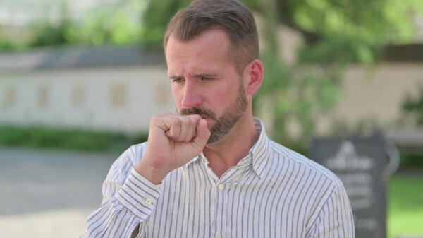 Outdoor Portrait of Mature Adult Man having Coughing 