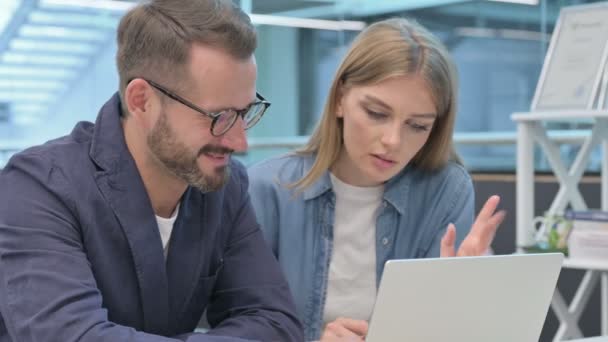 Maschio e femmina collega di lavoro su computer portatile insieme — Video Stock