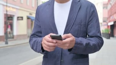 Sokakta Yürürken Smartphone 'da İnternet' e göz gezdirirken Erkek Ellerinin Çekimini Kapat