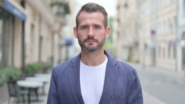 Portrait of Man Looking at Camera while Standing in Street — Stock Video