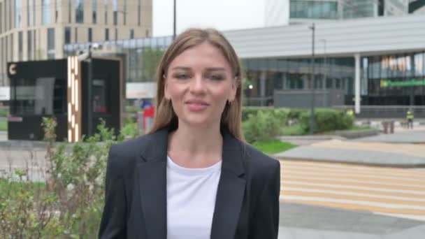 Возбужденная молодая предпринимательница разговаривает на онлайн-видео-звонок во время прогулки по улице — стоковое видео