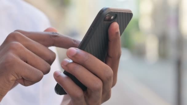 Close-up van de handen van de Afrikaanse man met behulp van Smartphone — Stockvideo