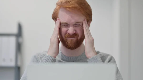 Vousy zrzavý muž s bolestí hlavy při používání notebooku — Stock fotografie