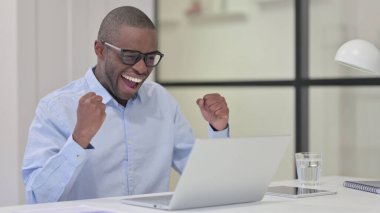 Başarılı Afrikalı Adam Laptop 'ta iş yerinde kutlama yapıyor 