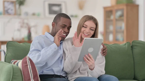 Interracial Couple Celebrating Success on Tablet at Home — Stock Photo, Image