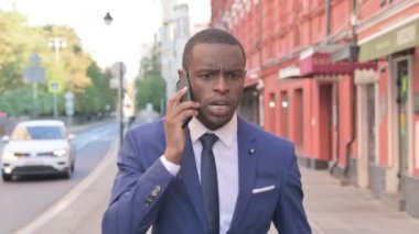 Yürüyen Afrikalı Genç İş Adamı Telefonda Sinirleniyor