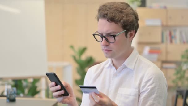 (Inggris) Portrait of Young Man having Online Payment Success on Smartphone — Stok Video