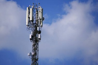 İletişim kulesi 3G ya da 4G ağ telefon şebekesi mavi gökyüzündeki silueti. İletişim standardının uygulanması 5G