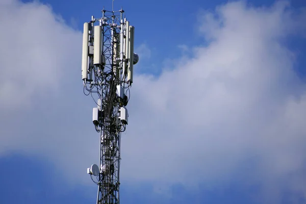 Communication tower 3G or 4G network telephone cellsite silhouette on blue sky. Implementation of communication standard 5G