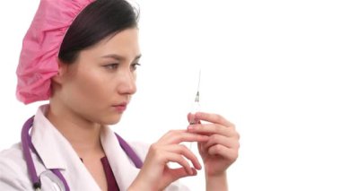 Genç bir kadın doktor elinde şırınga tutuyor.