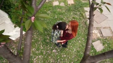A couple standing under the showered tree