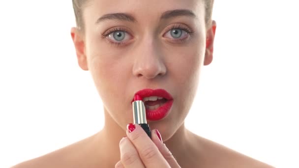 sensual woman painting lips with red lipstick