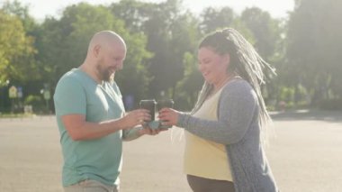 Güneşli bir günde sokakta konuşan ve kahve içen iki şişman arkadaş. Yaz tatili boyunca sohbet eden şişman adamlar. Standart olmayan güzel insanlar hayatın ve havanın tadını çıkarırlar..