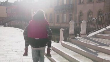 Yakışıklı Avrupalı adam Venedik sokaklarında muhteşem Asyalı kadınını sırtında taşıyor. Genç aşık hippi çift uzun bir geçmişi olan güzel bir ülkede eğleniyor. Aşk kavramı.