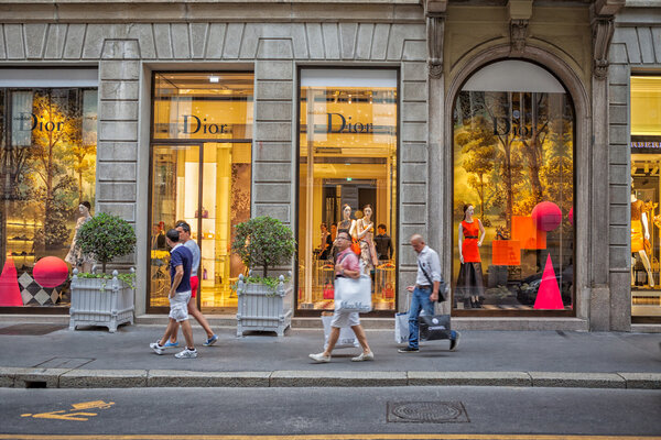 Milan, Italy - Circa August 2013: People walking near fashion Dior stores in Milan.