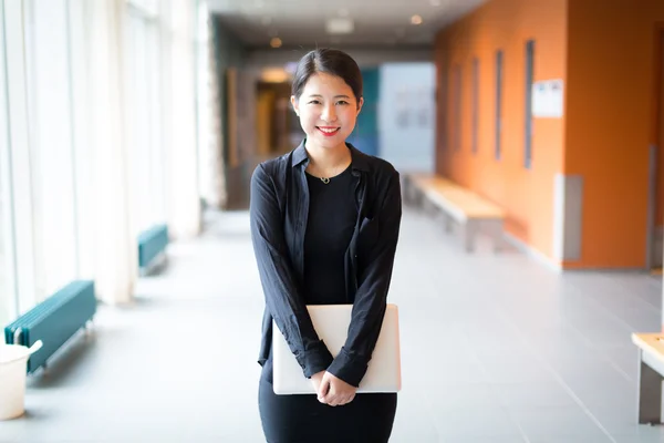 Asya kolej öğrenci ile bir dizüstü bilgisayar ayakta