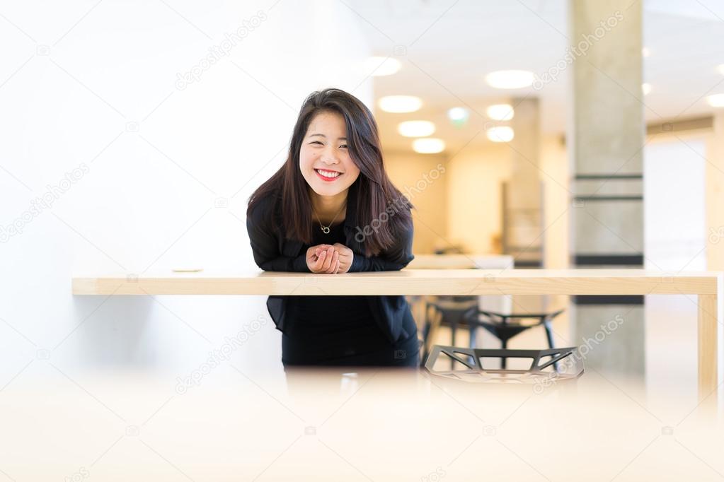 Asian college student standing at the high table at campus