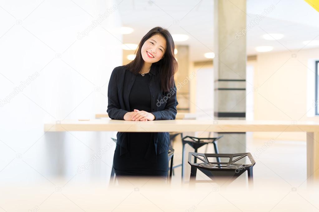 Asian college student standing at the high table at campus