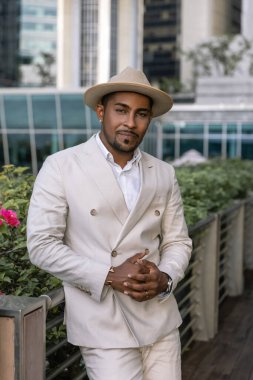 Modern Singapur şehrinin arka planına karşı açık renk bir takım elbiseyle uluslararası bir düğünde çekici bir damat. Kendine güveni güçlü bir birey izlenimi veriyor. Yüksek kalite fotoğraf