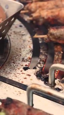 juicy kebabs on a barbecue grill with smoke. Relaxing and delicious barbecue in the backyard. A personal home outdoor grill using natural charcoal.Meat on fire. Grilled mushrooms. High quality 4k footage