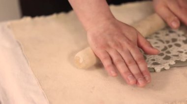 Potter rolling clay creating snowflake ornament in ceramic workshop. High quality 4k footage
