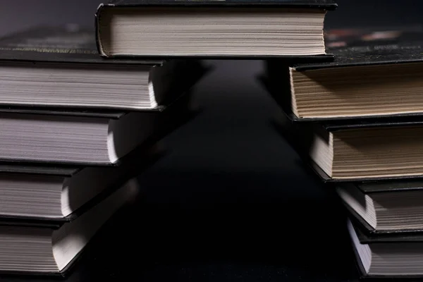 Stack of books. In the shape of an arch.