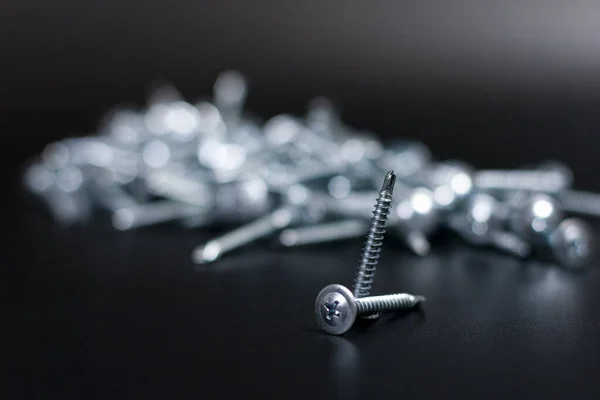 En el centro de la pantalla hay un montón de tornillos de metal blanco. —  Fotos de Stock