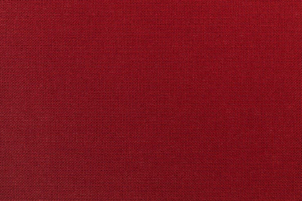 Fondo rojo oscuro de un material textil. Tejido con textura natural. Contexto . — Foto de Stock