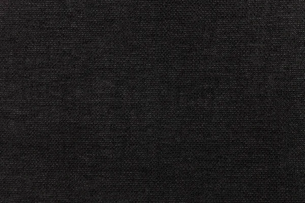Black background from textile material. Fabric with natural texture. Backdrop.