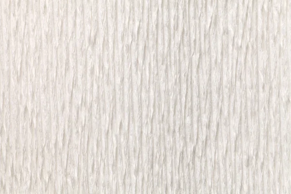 Textural white background of wavy corrugated paper, close-up.